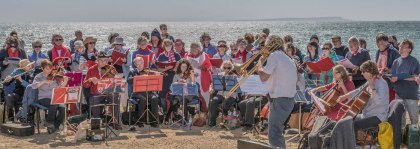 Group of musicians and singers on a beach