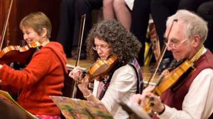 Three people playing violins