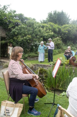 Woman playing a cello in the open air