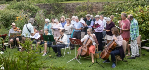 Group of musicians and singers in a garden