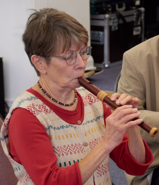 Woman blowing into a recorder